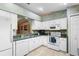 Well-equipped kitchen featuring modern appliances, white cabinets, and a breakfast bar, offering ample space for meal preparation at 1057 Shady Hollow Dr, Deland, FL 32724