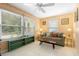 A bright living room features a large window, cozy seating, and neutral decor at 1057 Shady Hollow Dr, Deland, FL 32724