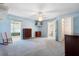 Comfortable main bedroom features neutral tones, carpet flooring, and direct access to the ensuite bathroom and closet at 1057 Shady Hollow Dr, Deland, FL 32724
