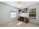 This home office features built-in shelving, natural light, and plenty of space at 1057 Shady Hollow Dr, Deland, FL 32724