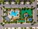 Aerial view of community pool and recreation area with a playground and lush landscaping at 1079 Quaker Ridge Ln, Davenport, FL 33896