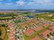 Aerial shot featuring the property in a neighborhood close to a golf course and multiple ponds at 1079 Quaker Ridge Ln, Davenport, FL 33896