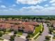 Aerial showcasing a well-maintained home with a two-car garage and manicured landscaping at 1079 Quaker Ridge Ln, Davenport, FL 33896