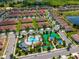 Aerial view showcasing the community pool, playground and lush landscaping at 1079 Quaker Ridge Ln, Davenport, FL 33896