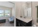 Bathroom features a vanity, mirror, and view into a sitting room at 1079 Quaker Ridge Ln, Davenport, FL 33896