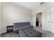 Neutral bedroom with futon, ottoman, and view to an ensuite bathroom at 1079 Quaker Ridge Ln, Davenport, FL 33896
