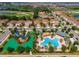 Aerial view of community with swimming pool, playground, green space, golf course and residential homes at 1079 Quaker Ridge Ln, Davenport, FL 33896