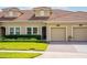 Well maintained single Gathering home featuring a red tile roof, manicured lawn, and a one-car garage at 1079 Quaker Ridge Ln, Davenport, FL 33896