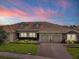 Charming single-Gathering home with a well-manicured lawn, paver driveway, and a two-car garage at 1079 Quaker Ridge Ln, Davenport, FL 33896
