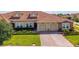 Beautiful single Gathering home featuring a red tile roof, manicured lawn, and a two-car garage at 1079 Quaker Ridge Ln, Davenport, FL 33896