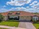 Beautiful single Gathering home featuring a red tile roof, manicured lawn, and a two-car garage at 1079 Quaker Ridge Ln, Davenport, FL 33896