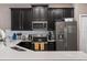 Kitchen featuring stainless steel appliances, dark wood cabinets, and white countertops at 1079 Quaker Ridge Ln, Davenport, FL 33896