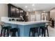 Well-appointed kitchen featuring a breakfast bar, stainless steel appliances, and ample counter space at 1079 Quaker Ridge Ln, Davenport, FL 33896