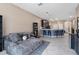 View from the living area into the kitchen, complete with a breakfast bar with seating at 1079 Quaker Ridge Ln, Davenport, FL 33896