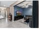 Open-concept living room featuring a large TV and neutral tones throughout at 1079 Quaker Ridge Ln, Davenport, FL 33896