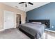 Bright main bedroom with large bed and access to an ensuite bathroom at 1079 Quaker Ridge Ln, Davenport, FL 33896