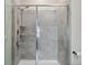 Walk-in shower with glass door and tiled walls and flooring at 1079 Quaker Ridge Ln, Davenport, FL 33896
