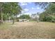 Lush backyard surrounded by mature trees and a wood fence, offering privacy and space at 1090 Wakefield Cir, Deltona, FL 32725