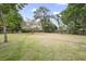 Large backyard with a big open grassy area and mature trees, great for outdoor activities at 1090 Wakefield Cir, Deltona, FL 32725