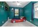 bedroom with a race car bed, ceiling fan, and colorful modern decor at 1090 Wakefield Cir, Deltona, FL 32725