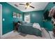 Cozy bedroom with an accent wall, ceiling fan, and a comfortable bed with a decorative throw blanket at 1090 Wakefield Cir, Deltona, FL 32725