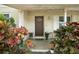 Inviting front porch adorned with vibrant foliage, leading to an attractive front door at 1090 Wakefield Cir, Deltona, FL 32725