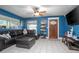 Bright living room boasts stylish tile flooring, ceiling fan, and an attractive front door at 1090 Wakefield Cir, Deltona, FL 32725
