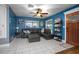 Cozy living room offers a comfortable seating arrangement, tile flooring, and a ceiling fan at 1090 Wakefield Cir, Deltona, FL 32725