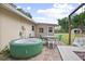 Private patio area featuring an inflatable hot tub, seating, and a swing for relaxation at 1090 Wakefield Cir, Deltona, FL 32725