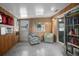 Cozy sunroom with wood paneling, featuring comfortable seating, natural light, and a view of the backyard at 1090 Wakefield Cir, Deltona, FL 32725