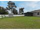 The backyard features a shed, privacy fence, and well-maintained grass at 116 Neal Dr, Deltona, FL 32738