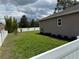 This backyard features a vinyl fence, well-maintained lawn, and shade trees at 116 Neal Dr, Deltona, FL 32738