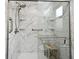 A modern bathroom featuring marble style tiling and a glass shower door at 116 Neal Dr, Deltona, FL 32738