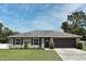 Charming single-story home with a well-manicured lawn and a two-car garage at 116 Neal Dr, Deltona, FL 32738