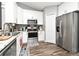 Modern kitchen with stainless steel appliances, white cabinets, and hardwood flooring at 116 Neal Dr, Deltona, FL 32738