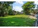 Lush backyard with large green lawn and trees, offering great space at 1228 Oakwood Ave, Daytona Beach, FL 32114