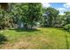 Large backyard with mature trees and plenty of space for activities at 1228 Oakwood Ave, Daytona Beach, FL 32114