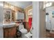Cozy bathroom featuring wood accents, patterned wallpaper, and vintage lighting at 1228 Oakwood Ave, Daytona Beach, FL 32114