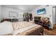 Bedroom with hardwood floors, natural light, tv, and a well-organized closet space at 1228 Oakwood Ave, Daytona Beach, FL 32114