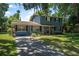 Inviting two-story house with a classic design, lush front lawn and mature trees shading the property at 1228 Oakwood Ave, Daytona Beach, FL 32114