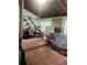 Enclosed sunroom area with tiled flooring, storage and window views at 1228 Oakwood Ave, Daytona Beach, FL 32114