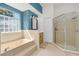 Bathroom with a large soaking tub and glass-enclosed shower at 1309 Wicklow Ln, Ormond Beach, FL 32174