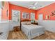 Cozy bedroom boasts a ceiling fan, wood dresser, and windows with bright natural light at 1309 Wicklow Ln, Ormond Beach, FL 32174