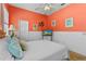 Comfortable bedroom includes a ceiling fan, TV, and windows with bright natural light at 1309 Wicklow Ln, Ormond Beach, FL 32174