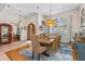 Bright dining area with an expansive table and a view of an office space, offering a flexible and modern living experience at 1309 Wicklow Ln, Ormond Beach, FL 32174