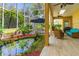 A screened patio with comfortable seating, an outdoor dining area, and a decorative pond at 1309 Wicklow Ln, Ormond Beach, FL 32174