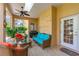 Covered patio featuring comfortable seating, ceiling fans, and access to the outdoors at 1309 Wicklow Ln, Ormond Beach, FL 32174