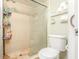 Bathroom with a toilet and a stand-up shower with a glass door at 1343 Rocky Rd, Kissimmee, FL 34744
