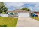 Charming single-story home with stone accents, a two-car garage, and a well-manicured lawn at 1343 Rocky Rd, Kissimmee, FL 34744