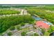 Wonderful aerial view of community amenities including pool, tennis courts, clubhouse, parking and beautifully landscaped grounds at 1481 Areca Palm Dr, Port Orange, FL 32128